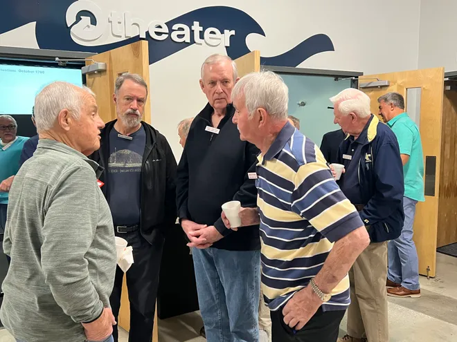 Members socializing before the meeting